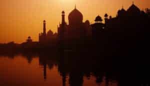 Sunset silhouette of a grand Taj Mahal.