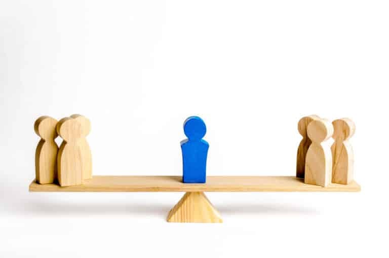 The leader stands on the scales between two groups of people. Resolving conflict situations. The union of two opposing groups of people. Conflict of interest. Leadership, choice side.