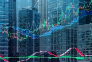 Colorful stock market candlestick charts and trend lines are overlaid across modern glass skyscrapers.